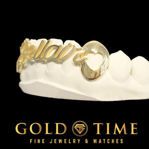 Opposite side of a gold cursive nameplate grill showing the second open heart canine cap