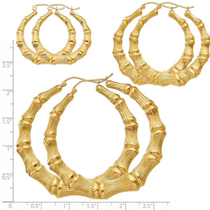 Three sizes of 14K gold bamboo hoop earrings on a ruler