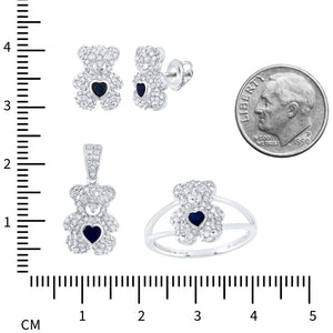 Teddy bear earrings, pendant, and ring next to a centimeter ruler and a dime for size