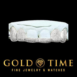 Six piece silver diamond dust tip grill shown on a dental mold