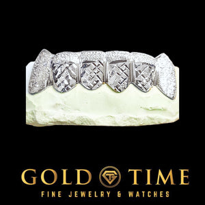 White gold 6 piece trillion cut grillz with diamond dust caps and canine fangs on a dental model