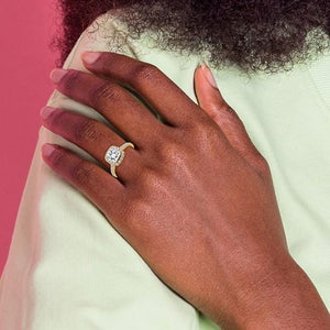 Hand wearing a 14K white gold cushion moissanite halo engagement ring