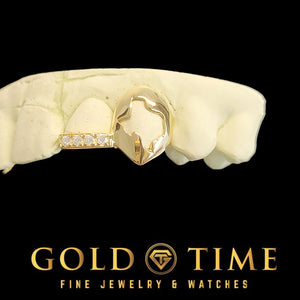 Gold open face canine cap with a custom Texas-shaped cut-out beside a moissanite-lined incisor tip