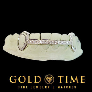 White gold open face grillz with a moissanite set bar running across the center of the teeth