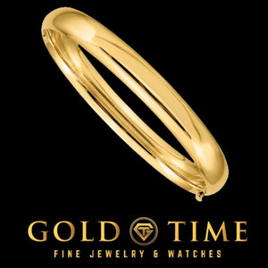Solid 14K gold oversized oval bangle with a polished domed profile