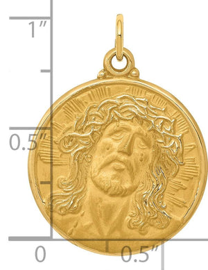 14k gold Jesus medallion pendant shown next to a ruler for size reference