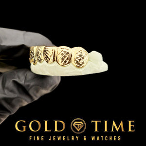 Close view of the raised box frames and trillion cut faces in yellow gold