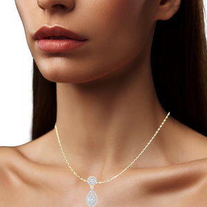 Woman wearing a gold diamond teardrop pendant on a chain