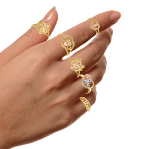 Hand wearing several 14k gold quinceanera ring designs for size comparison