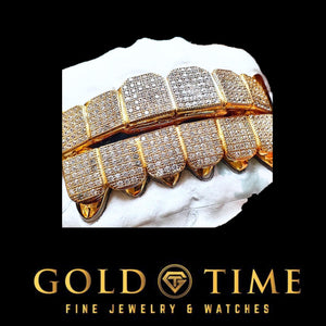 Angled view of a yellow gold CZ block bottom grillz set on a dental model