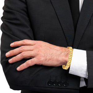 14K gold nugget bracelet worn at the shirt cuff with a dark suit