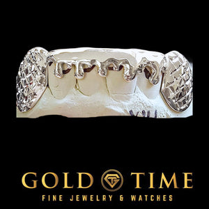 Silver 6 piece bottom grillz with trillion cut canines and drip design on a dental mold