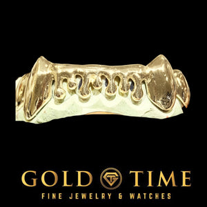 Custom 8 piece bottom drip grillz in yellow with pointed canine fangs and open melting drip shapes across the front teeth, on a dental mold