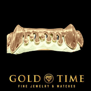 Custom 8 piece bottom drip grillz in rose with pointed canine fangs and open melting drip shapes across the front teeth, on a dental mold