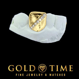 Yellow gold single tooth cap with a diagonal row of moissanite, shown on a dental mold