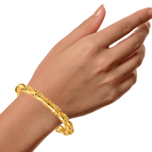 14K gold bamboo bangle worn on a wrist