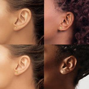 Four ears of different skin tones wearing small gold children's stud earrings