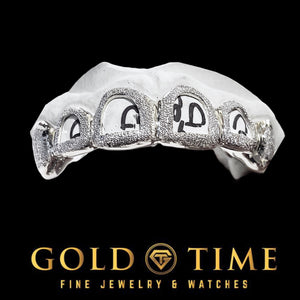 White 6 piece open face diamond dust grillz with box canines on a dental mold
