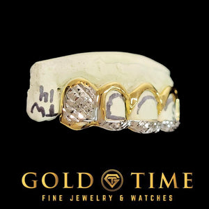 Two tone open face grillz on a cream model showing the box diamond cut canines