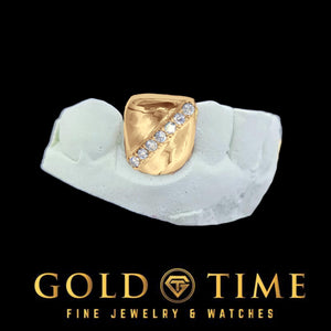Rose toned single tooth cap with a diagonal moissanite row, shown on a dental mold