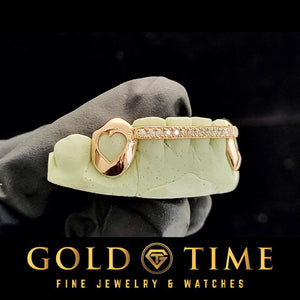 Rose gold grillz with heart design held by a hand on a black background, featuring 'Gold Time' branding.