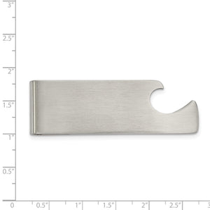 Stainless steel bottle opener money clip laid against an inch ruler for scale