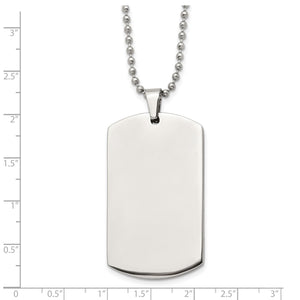 Stainless steel dog tag measured against a ruler at about two and a quarter inches tall