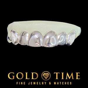 Silver 6 piece grillz with polished front teeth and diamond dust box canines on a dental model with the Gold Time logo