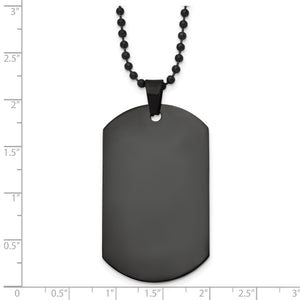 Black dog tag pendant against an inch scale, about 58mm by 29mm