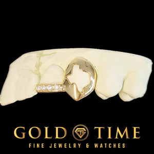 Yellow gold double cap grillz with a Texas state cut-out canine fang and a moissanite tipped incisor on a dental mold