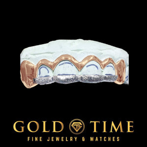 Rose gold 6 piece grill with solid canines and open window front teeth with white diamond dust tips on a mold