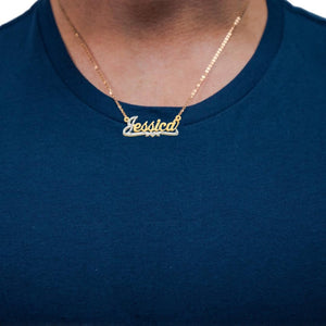 Man wearing the two tone diamond Jessica name necklace over a navy shirt