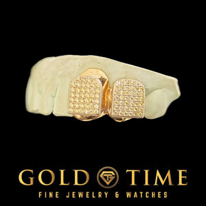 Close view of gold plated CZ block double cap grillz on a dental mold, showing the cubic zirconia block pattern