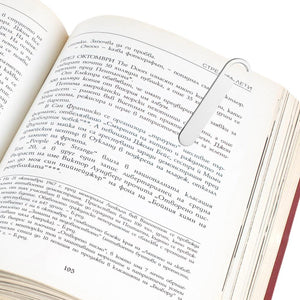 Sterling silver paperclip marking a page in an open book