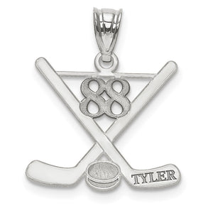 White gold hockey pendant with crossed sticks and the name Tyler