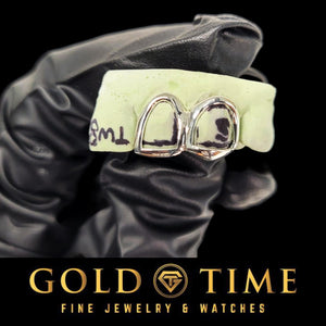 White metal open face double cap grillz on a marked dental mold held in a gloved hand, Gold Time