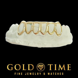 6 piece yellow gold open face grillz on a dental mold, top teeth only
