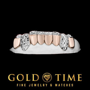 Angled view of two-tone grillz with white diamond-cut canines and trillion tips