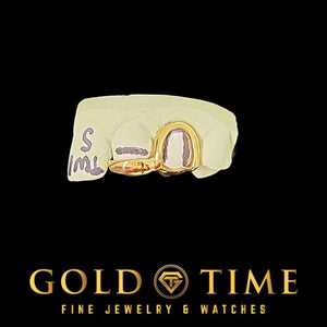 Yellow gold bottomless open canine and solid tip double cap on a labeled mold