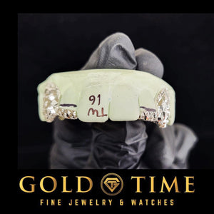 Side view of the silver grillz on a dental model showing the diamond dust canine cap
