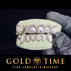 Angled view of the silver 12 piece diamond dust grillz set on its molds