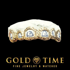 Custom 6 piece open face trillion cut grillz in gold with diamond-cut frames on a dental mold