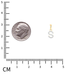 A 10k gold diamond initial pendant shown next to a dime for scale on a centimeter ruler