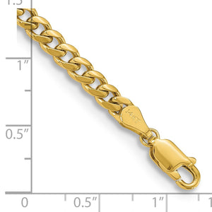 Close up of yellow gold Miami Cuban links and lobster clasp measured against a ruler