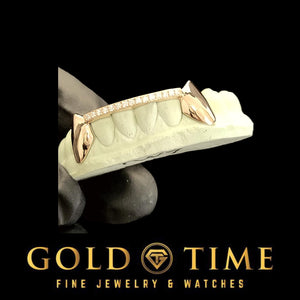 Custom rose gold fang grillz with moissanite tips, side angle