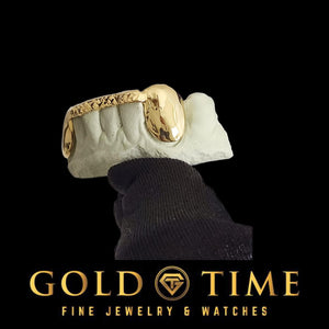 Angled view of solid canine and trillion tip bar grillz