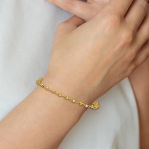Woman wearing a 14K gold rosary bracelet on her wrist