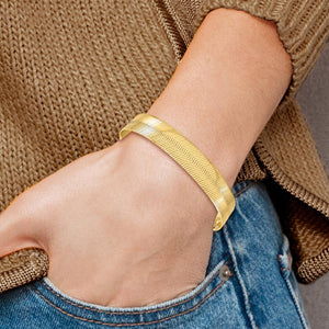 10mm gold herringbone bracelet worn on a wrist with a sweater and jeans