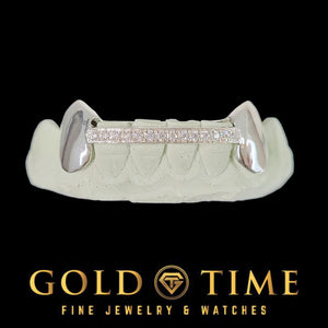 Silver solid canine fangs joined by a row of moissanite on a mold