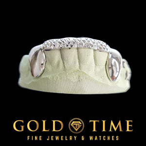 White gold grillz with solid canines and a trillion diamond-cut tip bar